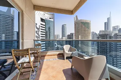 a balcony with chairs and a view of the city at VayK - Modern and Central 1BR in the Marina in Dubai