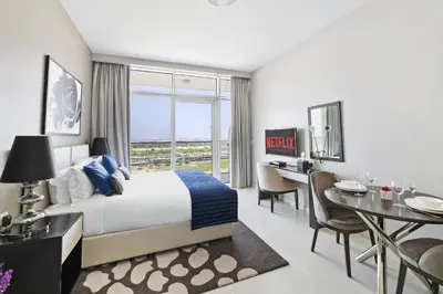 a hotel room with a bed and a dining room at VayK - Chic Hotel Style Studio in Damac Hills in Dubai