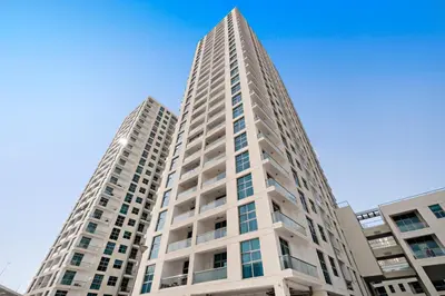 a tall white building with two tall buildings at VayK - Renovated 1BR in Dubai Marina in Dubai