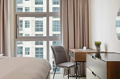 a bedroom with a desk and a bed and a window at VayK - Renovated 1BR in Dubai Marina in Dubai