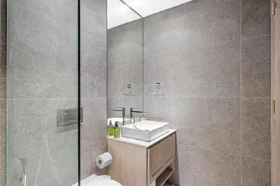 a bathroom with a toilet and a sink and a shower at VayK - Cozy Studio with a Balcony & Pool Views in Dubai