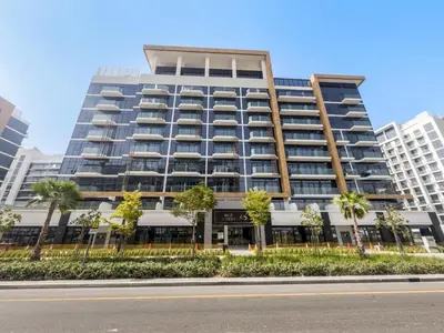 a tall building with palm trees in front of it at VayK - Modern Studio in Prime Meydan Area in Dubai