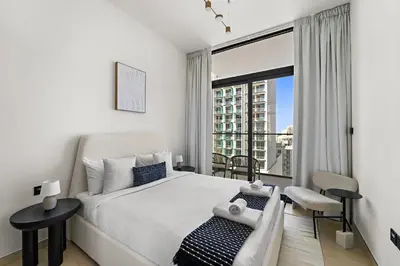 a bedroom with a bed and a large window at VayK - Amazing 1BR in Jvc in Dubai