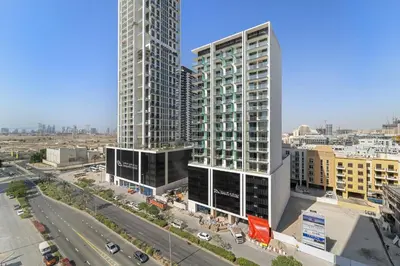 a city with two tall buildings and a highway at VayK - Amazing 1BR in Jvc in Dubai