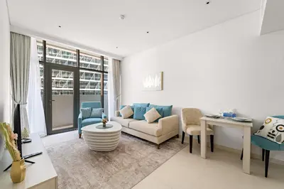a living room with a couch and a table at VayK - Great 1BR with Beach Access in Dubai