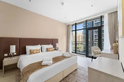 a bedroom with a large bed and a large window at VayK - Great 1BR with Beach Access in Dubai