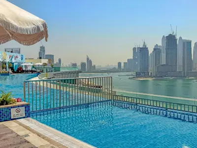 a swimming pool with a view of the city at VayK - Great 1BR with Beach Access in Dubai