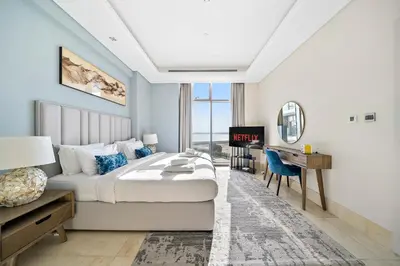 a bedroom with a bed and a desk and a computer at Upscale 1BR with Beach Access on Palm Jumeirah in Dubai