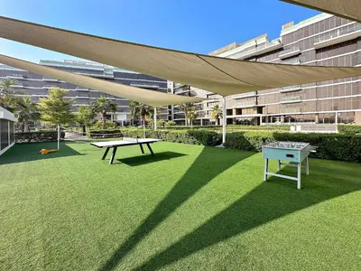 a patio with a ping pong table and a canopy at Upscale 1BR with Beach Access on Palm Jumeirah in Dubai