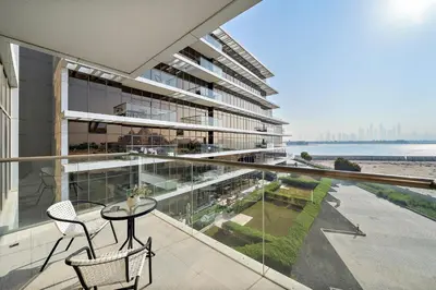 a balcony of a building with a table and chairs at Upscale 1BR with Beach Access on Palm Jumeirah in Dubai