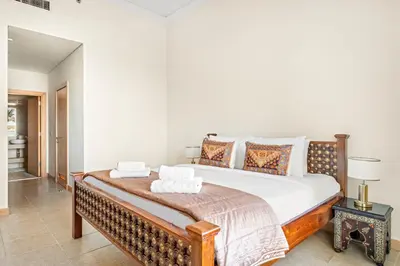 a bedroom with a large bed in a room at VayK - Beachfront 1BR on Palm Jumeirah with Sea View in Dubai