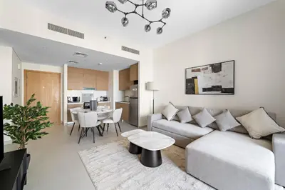 a living room with a couch and a table at VayK - Modern 1BR Getaway in Creek Harbour in Dubai