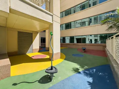 a building with a colorful floor with a pool at VayK - Modern 1BR in Downtown Dubai in Dubai