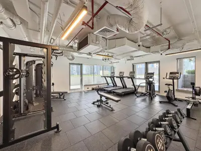 a gym with rows of exercise bikes and weights at VayK - Modern 1BR in Downtown Dubai in Dubai