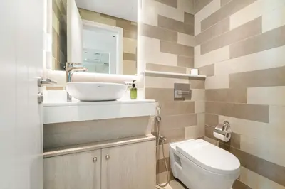 a bathroom with a sink and a toilet at VayK - Modern 1BR on Palm Jumeirah in Dubai
