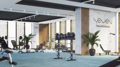 a gym with rows of exercise equipment and plants at VayK - Modern 1BR on Palm Jumeirah in Dubai