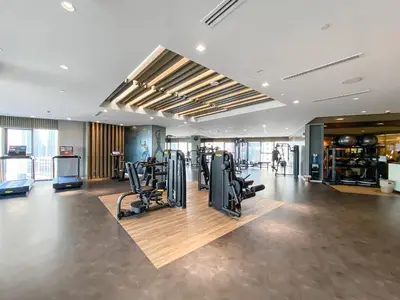 a gym with treadmills and cardio equipment in a building at VayK - Spacious 2BR Inside Hotel in Dubai