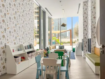 a waiting room with tables and chairs and windows at VayK - Elegant 2BR with Luxury Amenities in LIV Marina in Dubai