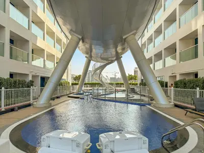 a view of a building with a water slide at VayK - Spacious 2BR with Private Pool in Science Park in Dubai