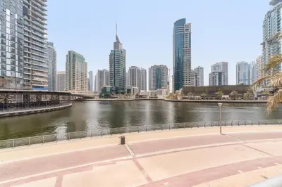 a river in a city with tall buildings at VayK - Luxe 2BR with Stunning Marina Views in Dubai