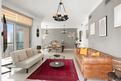 a living room with a couch and a table at VayK - Luxe 2BR with Stunning Marina Views in Dubai