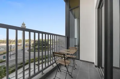 a balcony with benches and a view of a street at Modern 1BR Apartment with Balcony in Sobha Hartland in Dubai