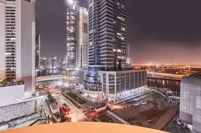 a view of a city at night with tall buildings at Home Away 2BR in Dubai