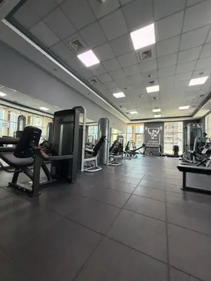a gym with chairs and machines in a room at Prime location cozy apartment in Dubai