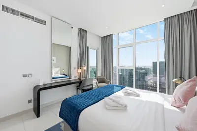 a hotel room with a bed and a large window at Luxury 2BDR In Burj Khalifa View Business Bay in Dubai