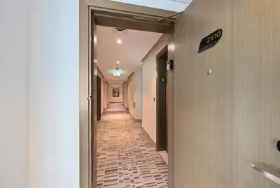 a hallway with a long corridor with a tile floor at Luxury 2BDR In Burj Khalifa View Business Bay in Dubai
