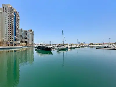 a group of boats docked in a harbor with buildings at VayK - Spacious 2BR with Private Gym & Beach Access in Dubai