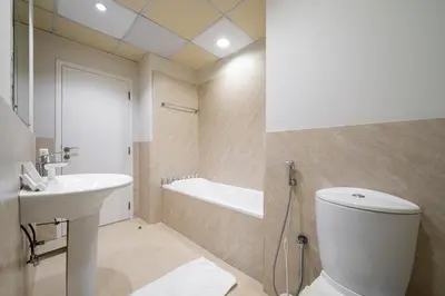 a bathroom with a toilet and a sink and a bath tub at Luxury Beachfront 4BR with Sea & Marina Views in Dubai