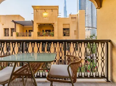 a balcony with a table and chairs and a building at Yansoon 4 in Dubai