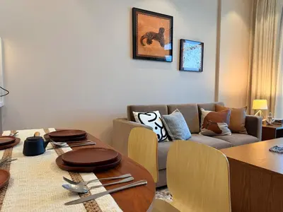 a living room with a couch and a table at Spacious 1BR- Sepcoo III Residence Al Furjan-1009 in Dubai