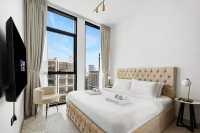 a bedroom with a large bed and a large window at New! Cozy 1BR in Binghatti House Pool and Gym in JVC in Dubai