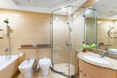 a bathroom with a shower and a toilet and a sink at Lux 2BR in Dubai Marina Walk to Beach & Metro in Dubai