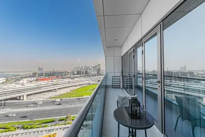a balcony with a table and a view of a highway at Escape24 Elegant 1BR with City View near Dubai Mall in Dubai