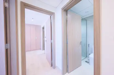 an open door to a bathroom with a toilet at Spacious 2BHK at Azizi Riviera 22 Meydan in Dubai