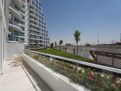 a balcony with a garden on a building at Blissful Retreat 1BR with 1GR Study Sleeps 4 in Gemz 05 in Dubai
