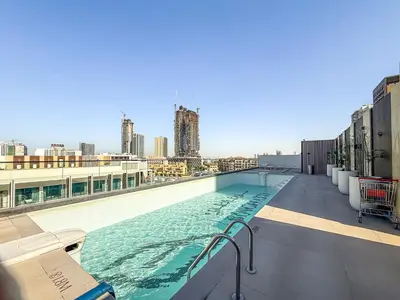 a large swimming pool on top of a building at ALiving Brand New & Modern Studio I Binghatti Galaxy, JVC- G01 in Dubai