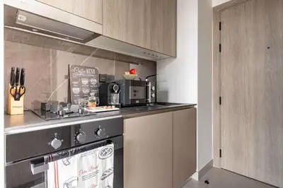a kitchen with a stove and a microwave at Frank Porter - Oxford Boulevard in Dubai