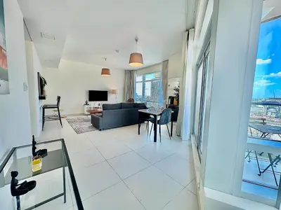 a living room with a couch and a table at EasyGo - Elegant 1BR in Downtown Dubai in Dubai