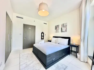 a bedroom with a large bed in a room at EasyGo - Elegant 1BR in Downtown Dubai in Dubai