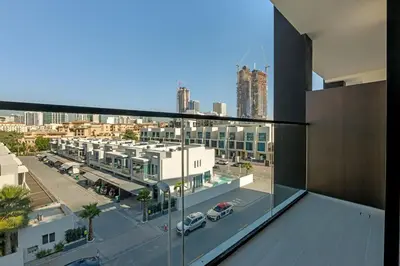 a view of a city from the balcony of a building at Charming Studio in Binghatti Galaxy JVC in Dubai