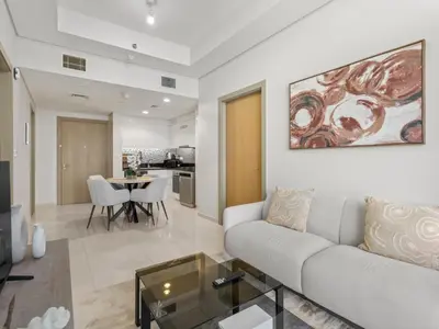 a living room with a couch and a table at Sophisticated 2BDR Living In Aykon City Business B in Dubai