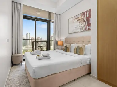 a bedroom with a large bed and a large window at Sophisticated 2BDR Living In Aykon City Business B in Dubai