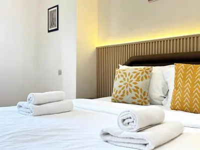 a hotel room with towels on a bed at JBR l Full Sea View l 4BR l 3min to Beach l 7-12PAX in Dubai