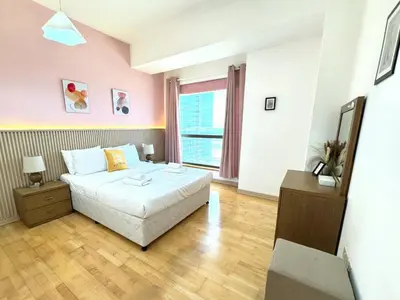 a bedroom with a bed and a large window at JBR l Full Sea View l 4BR l 3min to Beach l 7-12PAX in Dubai