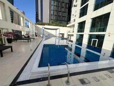 a swimming pool in the middle of a building at Signature Prestige 1BR Sleeps 4 -Damac Central in Dubai