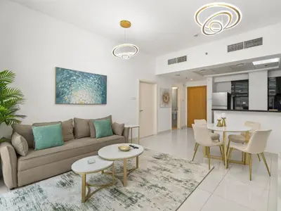 a living room with a couch and a table at Signature Prestige 1BR Sleeps 4 -Damac Central in Dubai